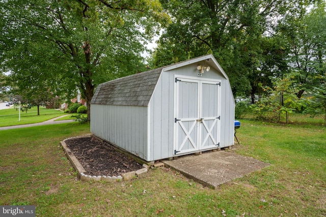 view of outbuilding with a yard