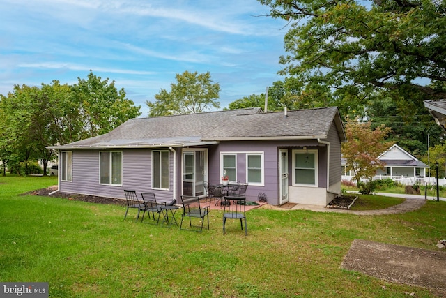 back of property featuring a lawn