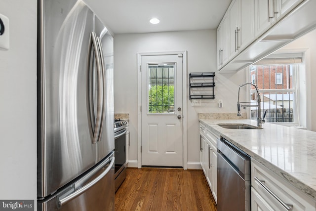 kitchen featuring white cabinets, stainless steel appliances, sink, and a wealth of natural light