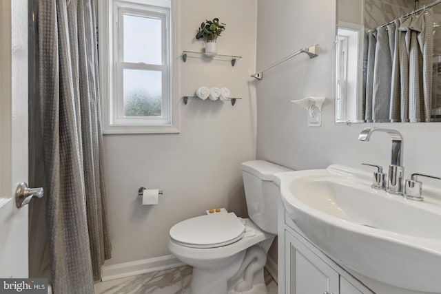 bathroom with walk in shower, vanity, and toilet