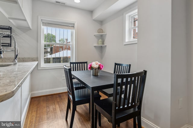 dining area featuring hardwood / wood-style flooring and sink