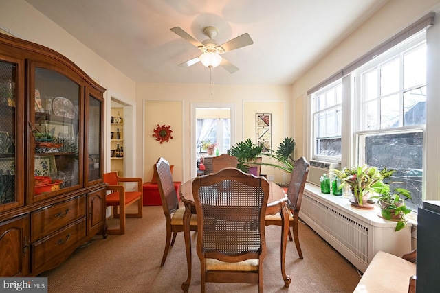 carpeted dining room featuring ceiling fan and a wealth of natural light