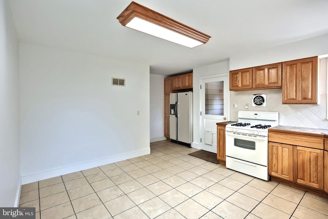 kitchen featuring light tile patterned floors and white appliances