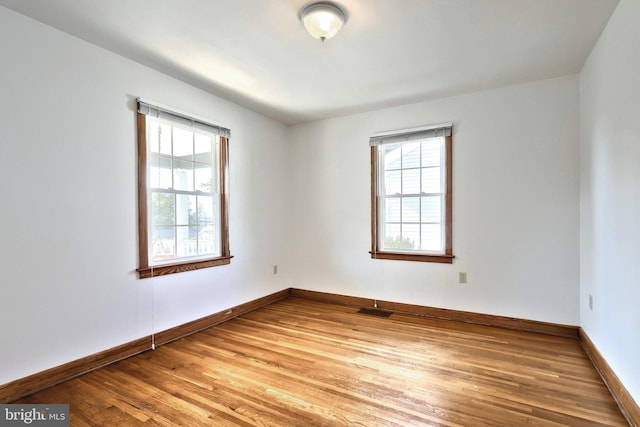 spare room with wood-type flooring