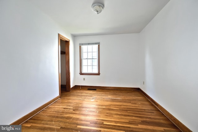 spare room featuring hardwood / wood-style floors