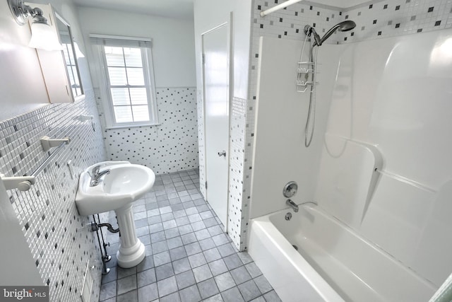 bathroom featuring tub / shower combination, tile patterned flooring, and tile walls