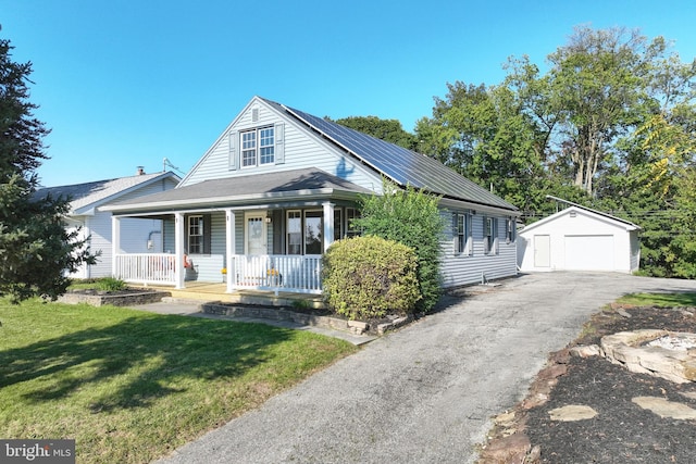 view of front of property featuring a garage, a front yard, an outdoor structure, and covered porch