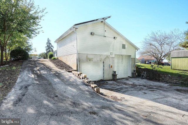 rear view of house with a garage