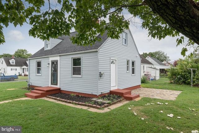 back of house with a yard