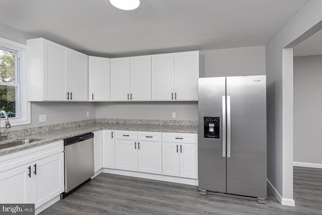 kitchen featuring dark hardwood / wood-style floors, white cabinets, appliances with stainless steel finishes, and sink