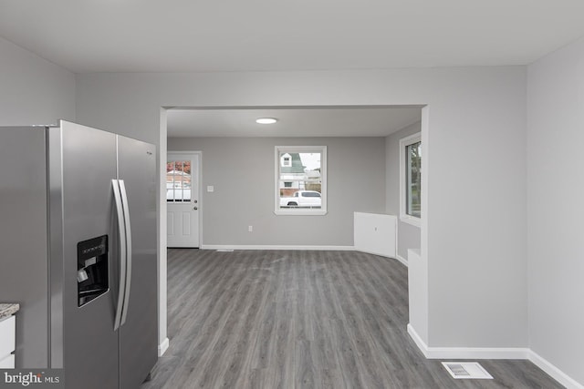 kitchen with hardwood / wood-style floors and stainless steel fridge