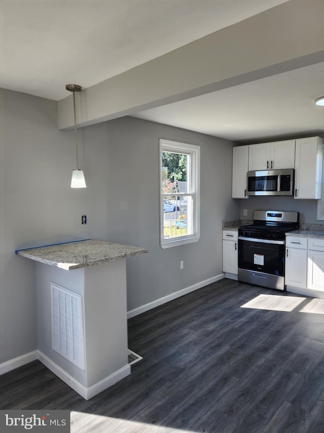 kitchen with decorative light fixtures, appliances with stainless steel finishes, dark hardwood / wood-style floors, and white cabinetry