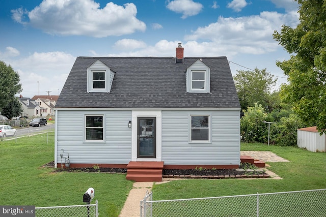 cape cod home with a front lawn and a shed