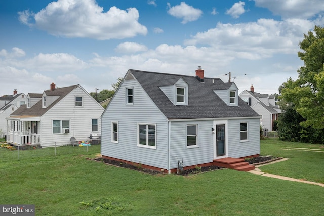 rear view of house featuring a yard