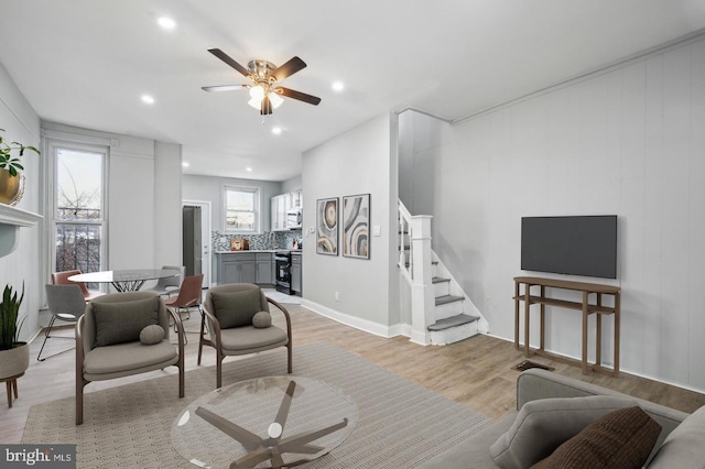 living room featuring light hardwood / wood-style floors, plenty of natural light, and ceiling fan