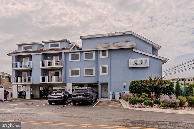 view of building exterior with uncovered parking