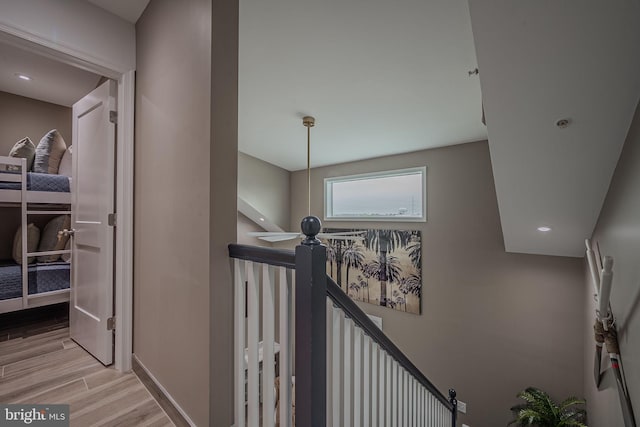 stairs with hardwood / wood-style floors