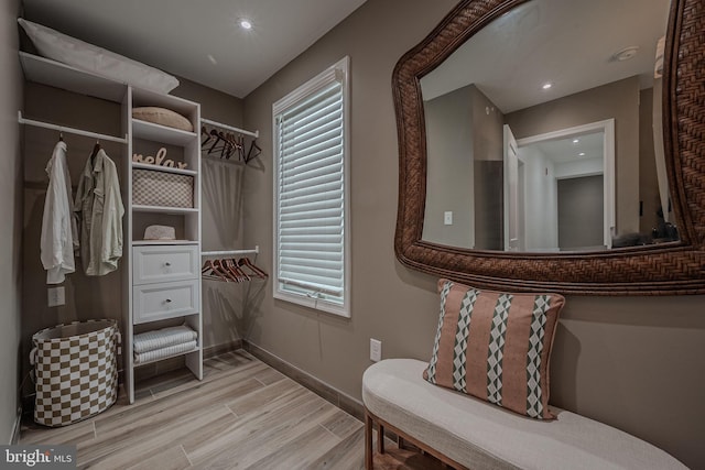 walk in closet featuring light hardwood / wood-style floors