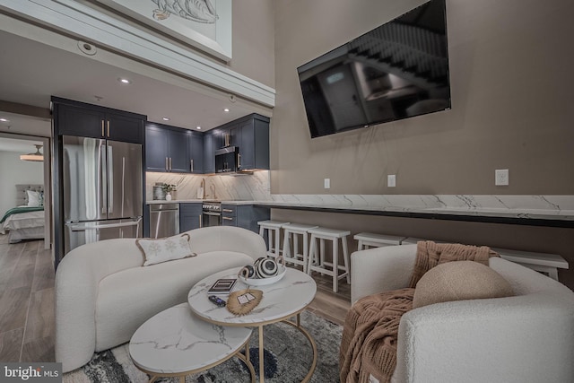 living room featuring light wood finished floors and recessed lighting