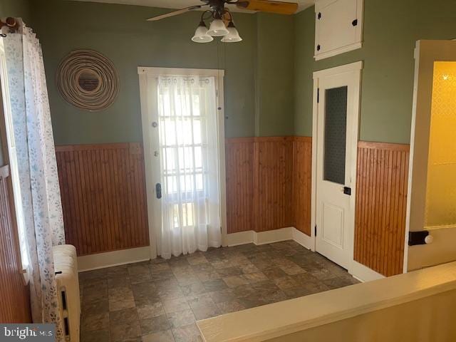 interior space with radiator and ceiling fan