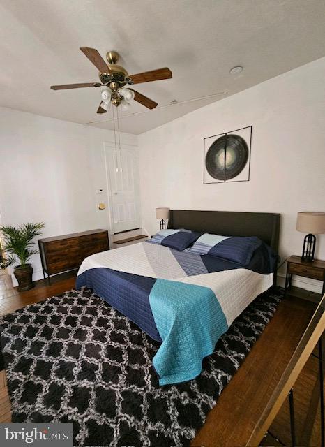 bedroom featuring dark wood-type flooring and ceiling fan