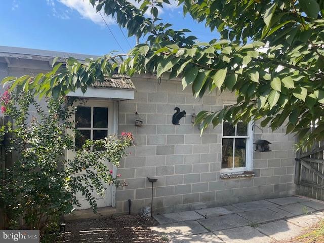 view of property exterior with a patio area