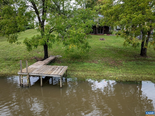 dock area featuring a yard and a water view