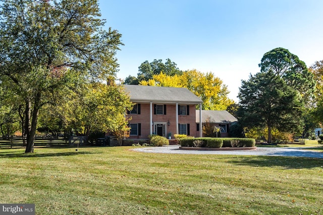 colonial inspired home with a front yard