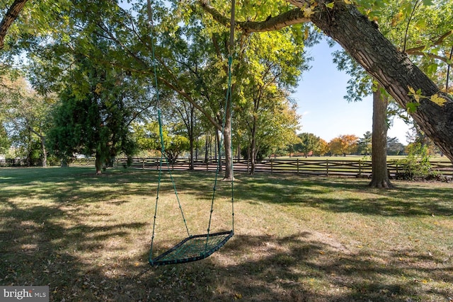 view of property's community with a lawn and a rural view