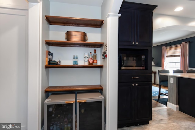 bar featuring wine cooler and crown molding