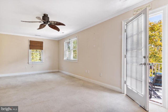 carpeted empty room featuring crown molding and ceiling fan