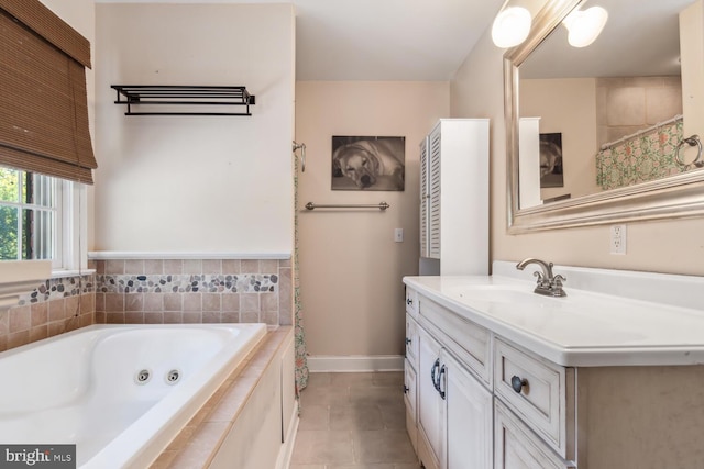 bathroom featuring vanity, tile patterned flooring, and tiled bath