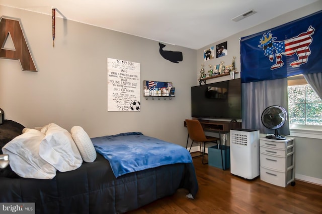 bedroom with dark hardwood / wood-style floors