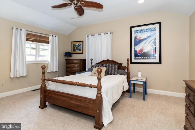 bedroom with ceiling fan, light carpet, and vaulted ceiling