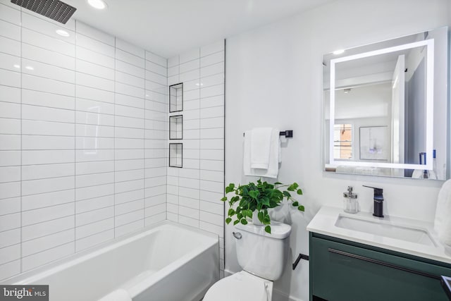 full bathroom featuring tiled shower / bath combo, vanity, and toilet