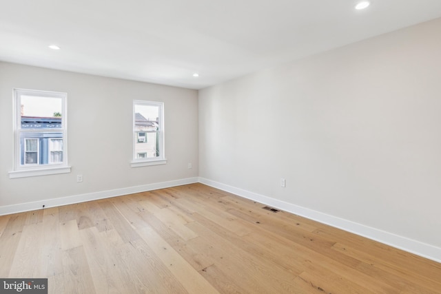 unfurnished room with light hardwood / wood-style floors