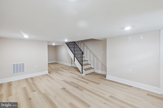 basement with light hardwood / wood-style floors