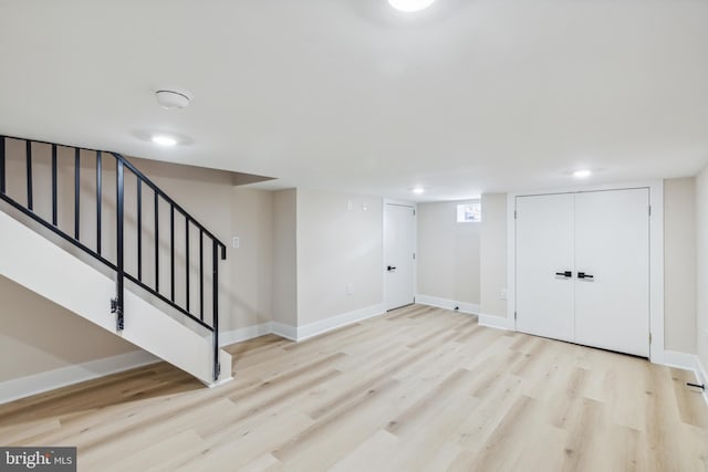 basement with light hardwood / wood-style flooring