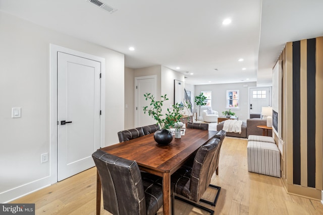 dining space with light hardwood / wood-style floors