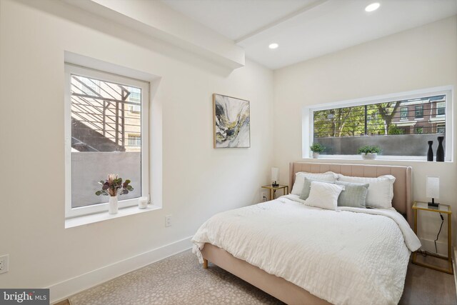 carpeted bedroom featuring multiple windows