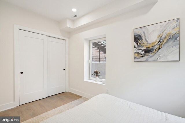 bedroom featuring a closet and light hardwood / wood-style floors