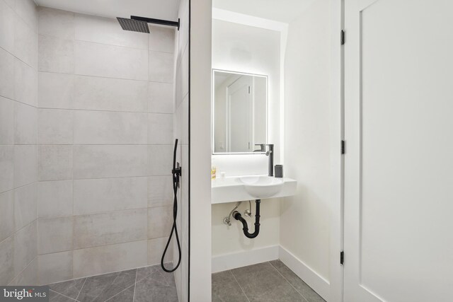 bathroom with sink, tile patterned floors, and tiled shower