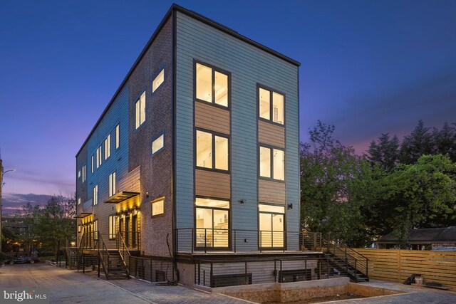 view of back house at dusk