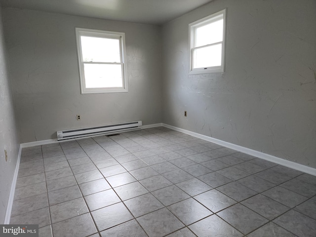 unfurnished room featuring a baseboard radiator and light tile patterned flooring