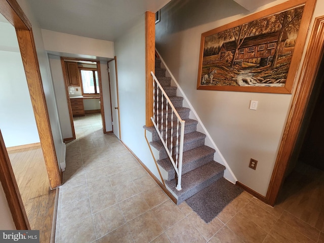 staircase featuring tile patterned flooring