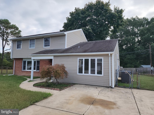 view of property featuring a front yard and a patio