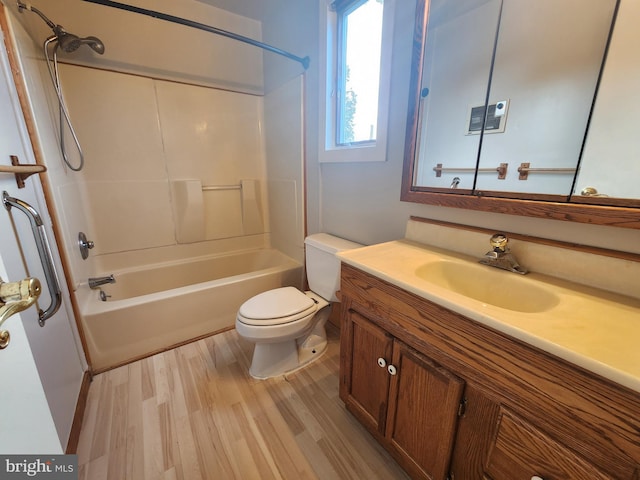 full bathroom featuring tub / shower combination, vanity, hardwood / wood-style floors, and toilet