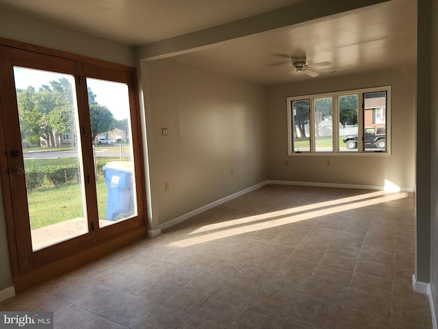 spare room with light tile patterned floors, ceiling fan, and plenty of natural light