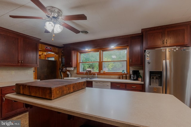 kitchen with dishwasher, stainless steel fridge with ice dispenser, sink, black refrigerator, and ceiling fan