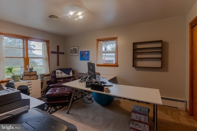 carpeted office featuring a baseboard heating unit